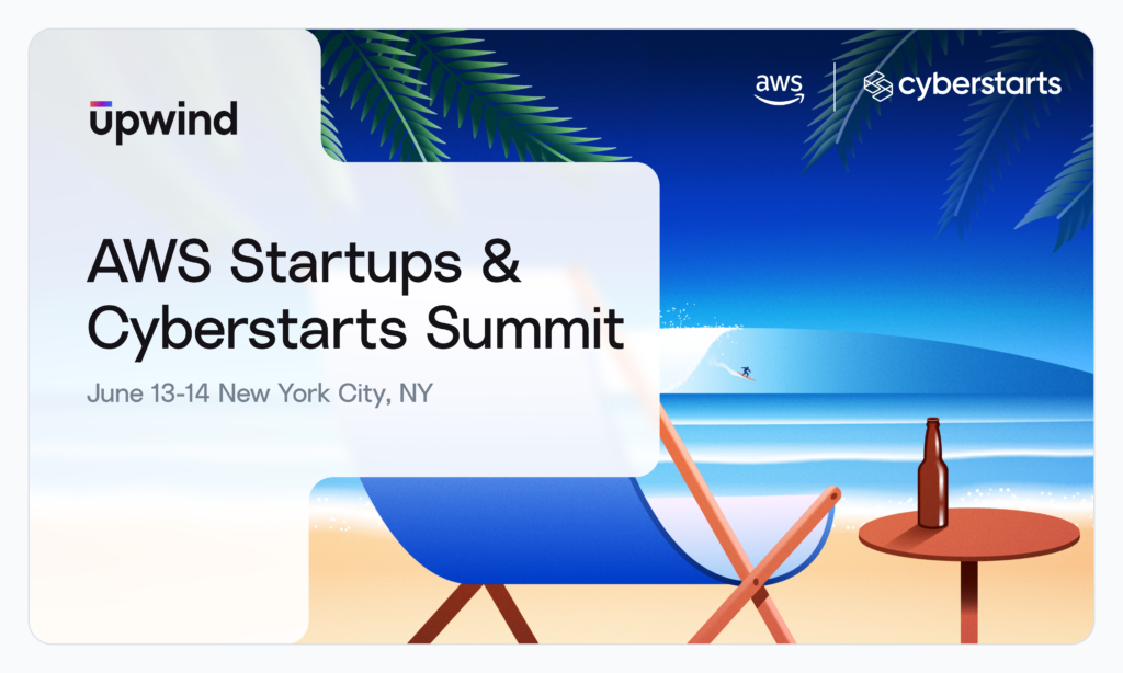 A promotional banner for the AWS Startups & Cyberstarts Summit, held on June 13-14 in New York City, NY. Features a beach scene with a lounge chair, table, and a drink, along with logos for Upwind, AWS, and Cyberstarts.