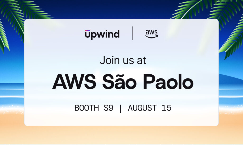 Invitation graphic for an AWS event in São Paulo, presented by Upwind and AWS, featuring a beach background with palm leaves. Text reads, Join us at AWS São Paulo, Booth S9, August 15.