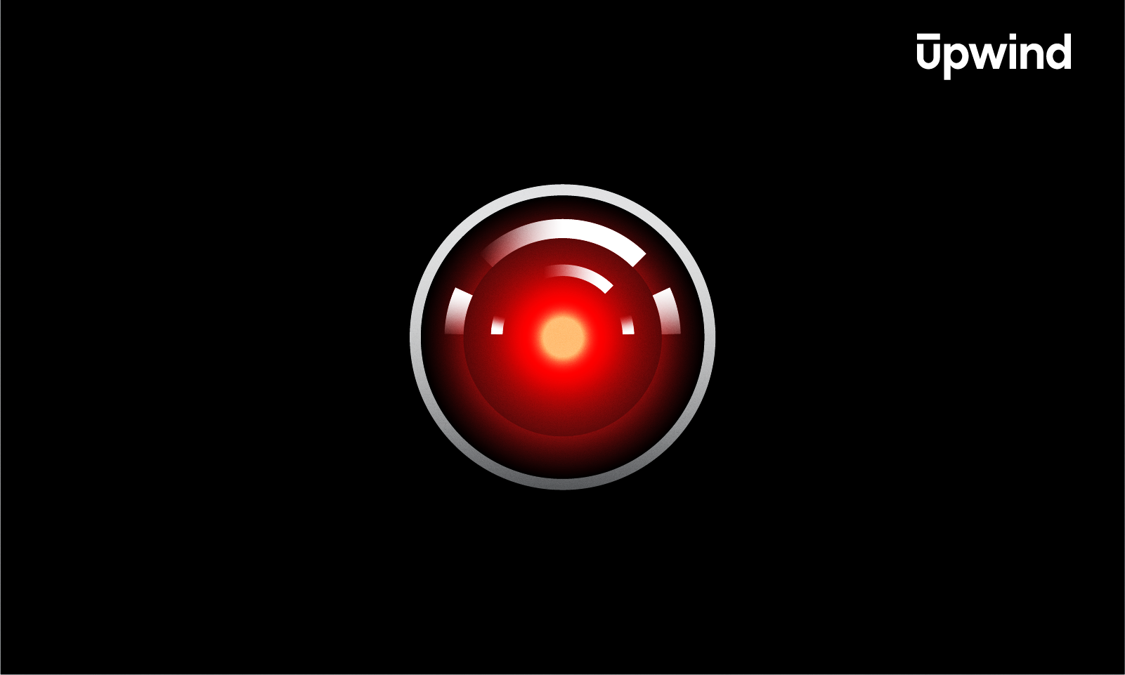 A glowing red lens with a metallic rim centered on a black background, resembling a robotic eye, evokes the question: What Is Adversarial AI? The word upwind appears in white text at the top right corner.