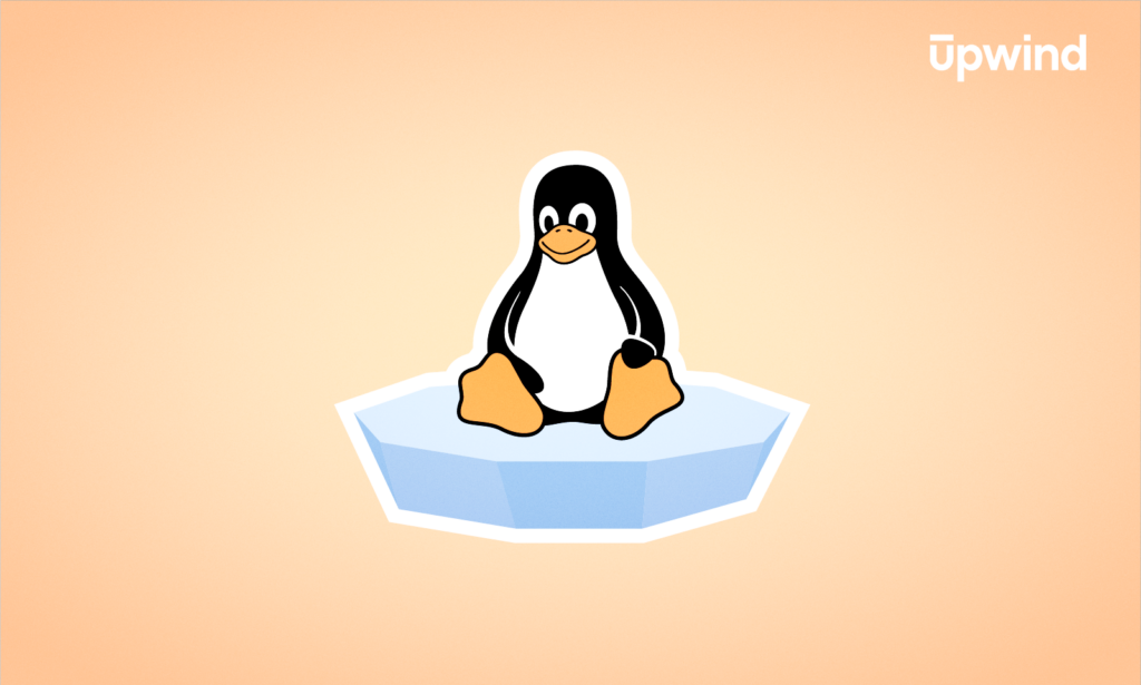 A cartoon penguin sits on a floating piece of ice against a pale orange background, with the upwind logo in the top right corner—a playful nod to “What is the Linux Kernel.”.